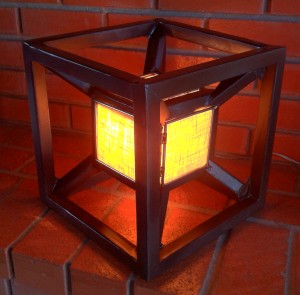 Hypercube with a 60W bulb illuminating the inside cube