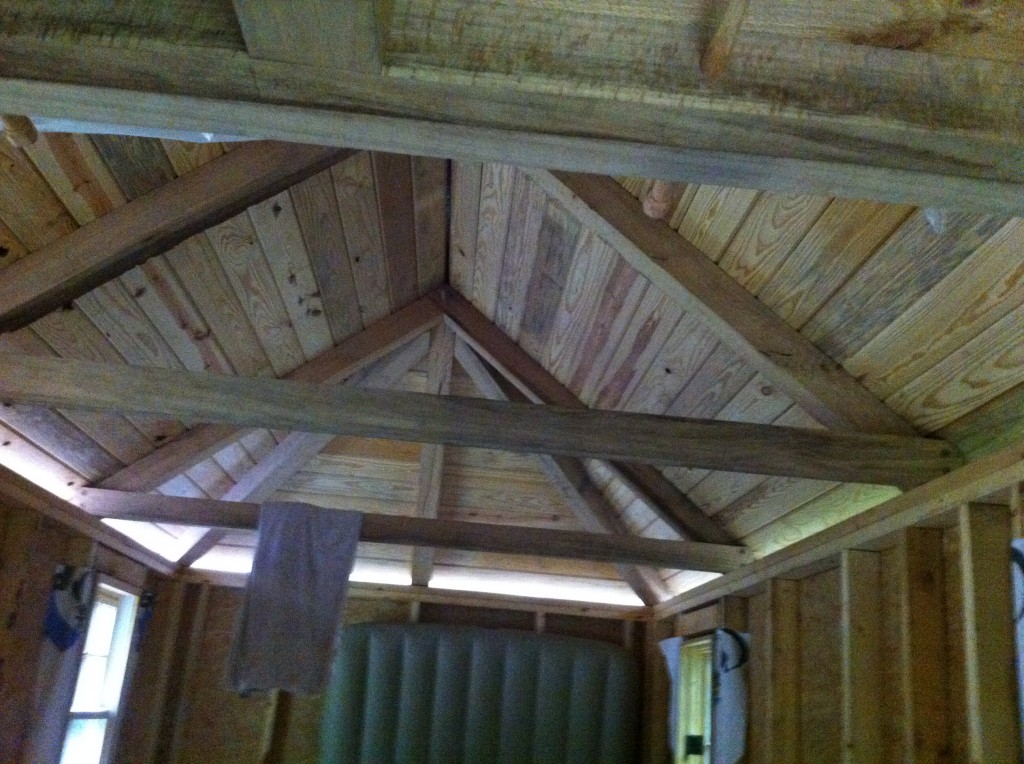 Inside of tiny home looking at the timber-framed hipped roof (9.5/12 pitch was tricky). Although the house isn't quite done, the owner already moved in with his kids.